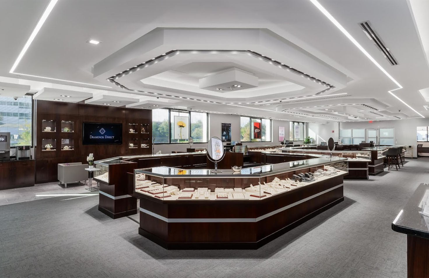 Diamonds Direct Diamonds Direct showroom interior with glass display cases showcasing diamond rings and fine jewelry collections.