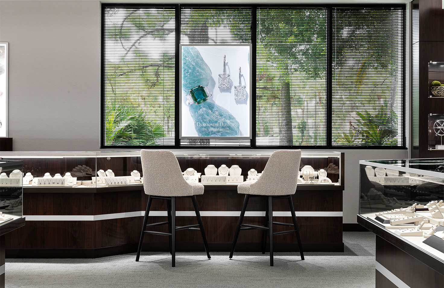 Diamonds Direct Diamonds Direct showroom interior featuring diamond showcases with elegant seating.