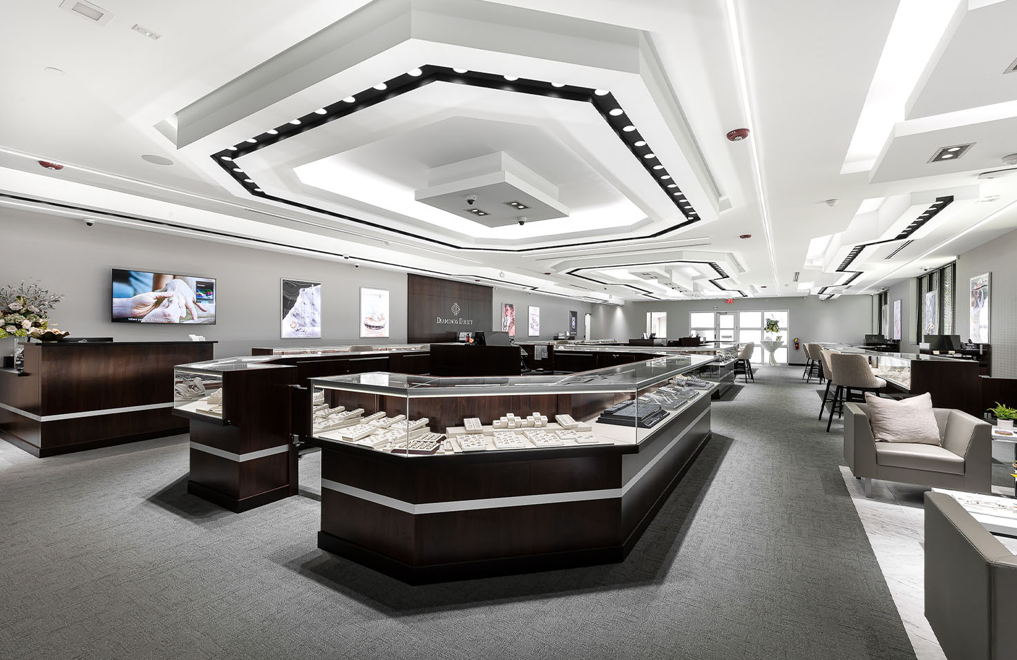 Diamonds Direct Diamonds Direct showroom with illuminated glass display cases featuring engagement rings.