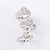 Three white gold diamond engagement rings with oval, round, and emerald-cut settings displayed on a light background.